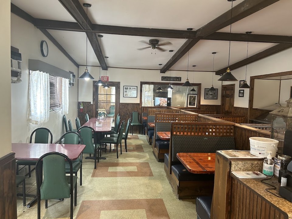 Classic diner tables with red booths and counter seating.